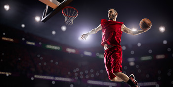Pic of player about to slam dunk a basketball for the win